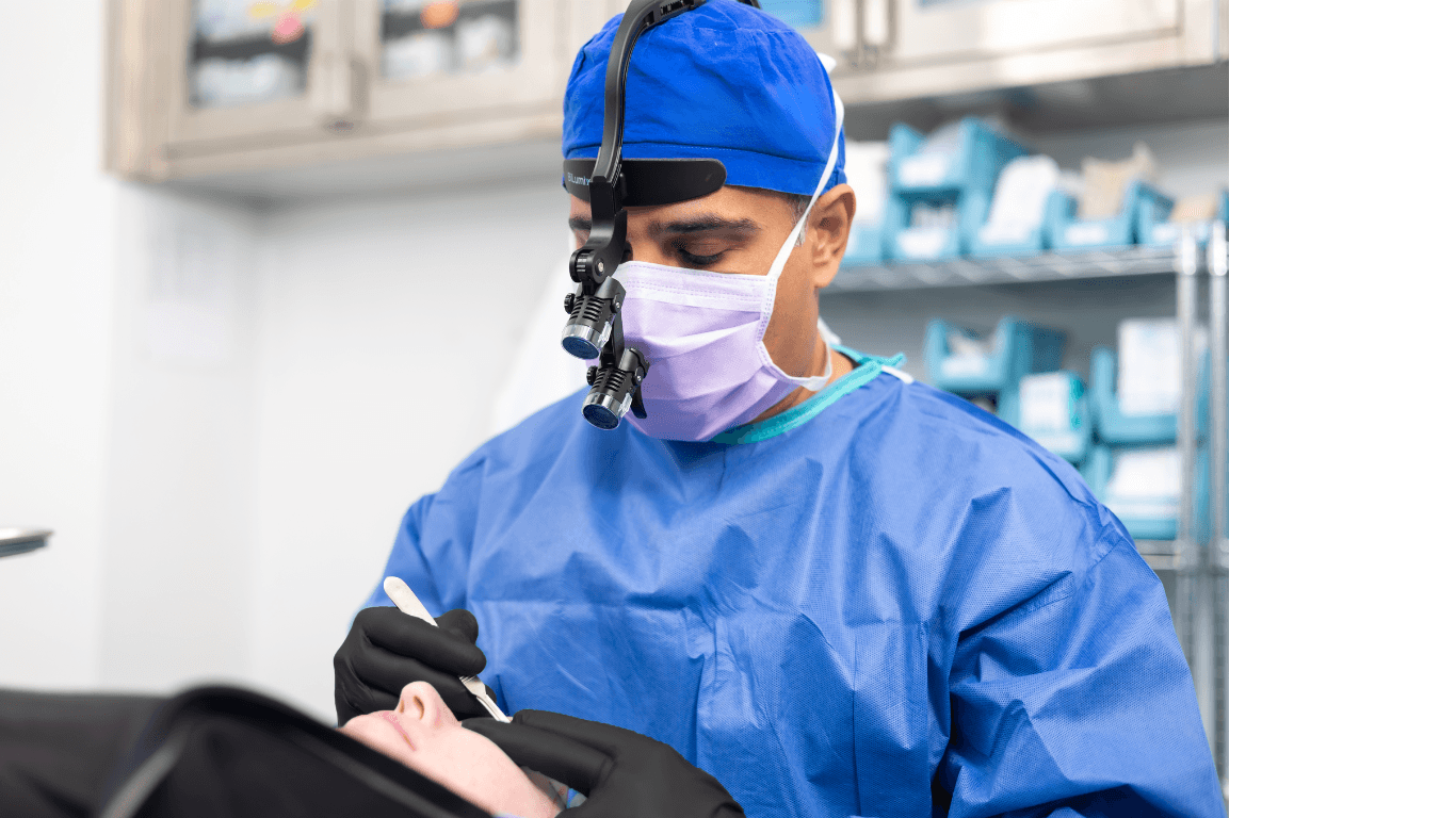 Oculofacial surgeon examining patient periocular region with loupes